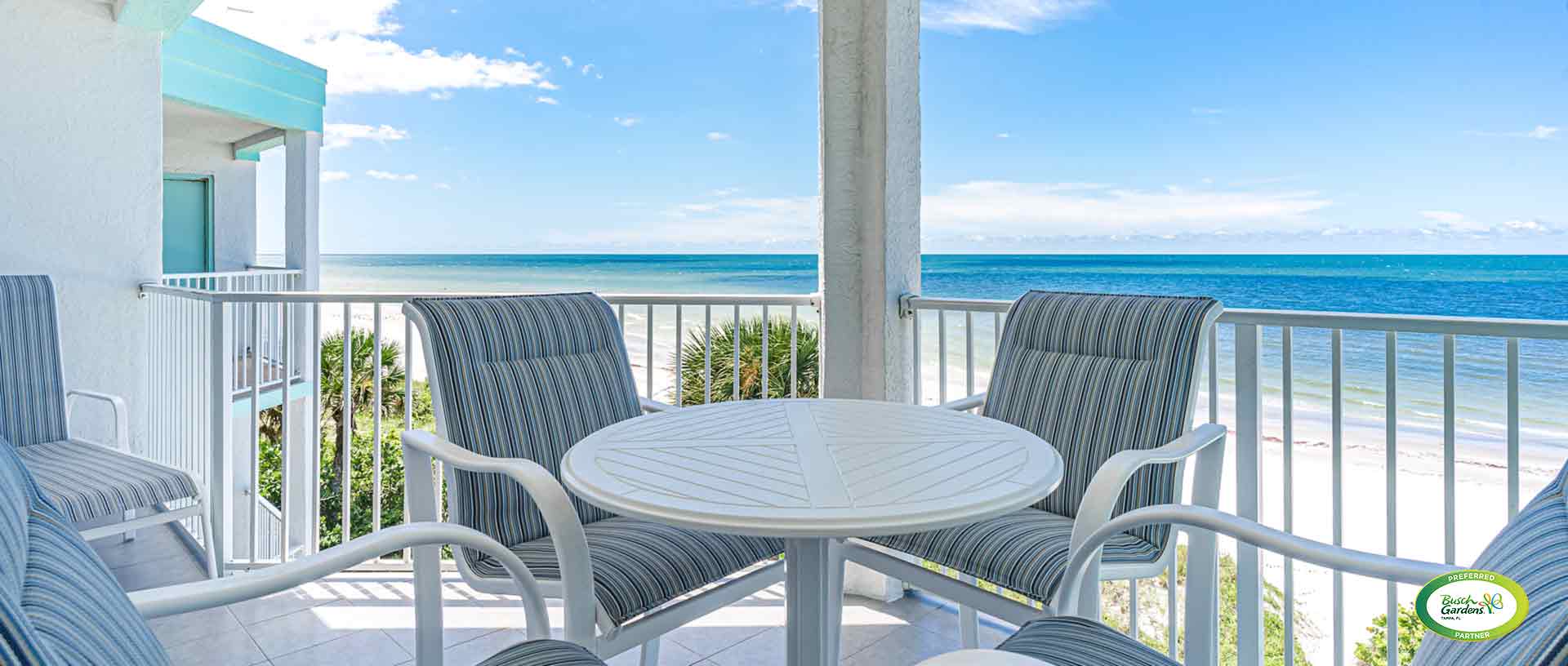 covered balcony table and chairs with beach view