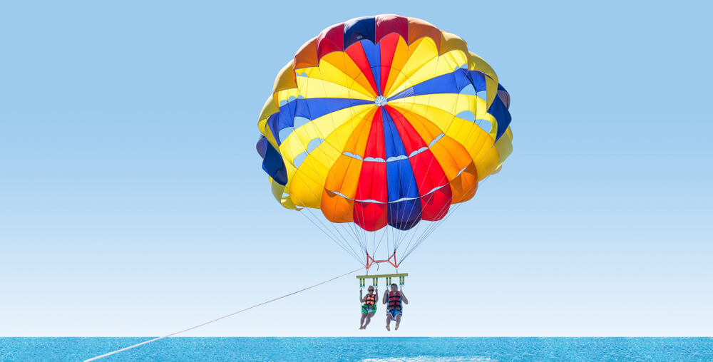 Photo of people parasailing during a Florida Gulf Coast vacation