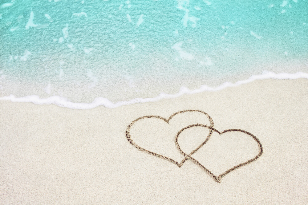Photo of two hearts drawn on the beach: romantic getaways in Florida on a budget