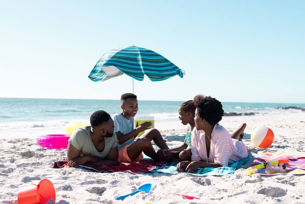family laying at the beach during a winter escape on the Florida Gulf Coast