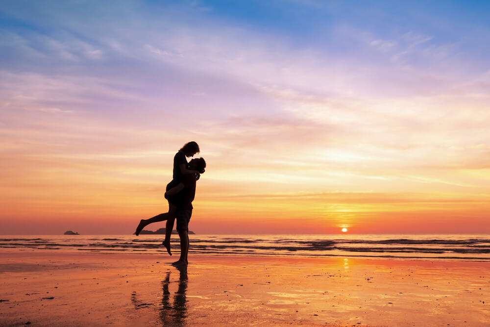 view of shadowed couple at the beach at sunset: Florida weekend getaways for couples