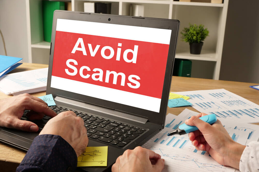 Graphic on computer screen saying "Avoid Scams"