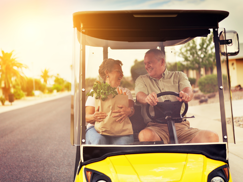 Couple taking their golf cart rental around Indian Rocks Beach