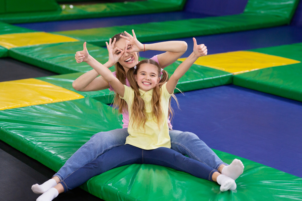 Parent and child at trampoline park enjoying rainy day activities in Florida