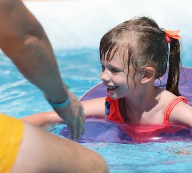 Water Safety Tips: Young girl in pool within arm's reach of her dad | Plumlee Indian Rocks Beach Vacation Rentals
