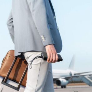 Man at airport carrying portable charging port | Plumlee Indian Rocks Beach Rentals