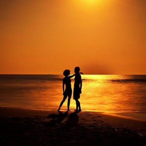 Couples Silhouette on the Beach at Sunset | Plumlee Realty