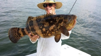 Man holding a giant fish | Plumlee Indian Rocks Beach Vacation Rentals