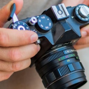 Person Adjusting Digital Camera Settings | Plumlee Realty