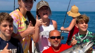 Family holding their catch of the day on the water | Plumlee Indian Rocks Beach Vacation Rentals