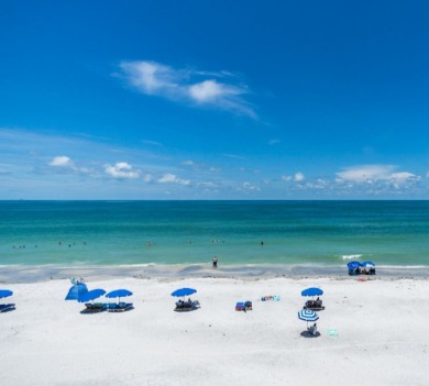 Blue umbrellas on the white sand of Indian Rocks Beach, Florida | Plumlee Vacation Rentals