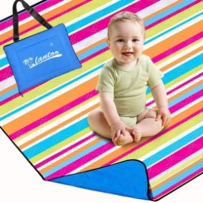 Baby sitting on portable beach mat | Plumlee Vacation Rentals