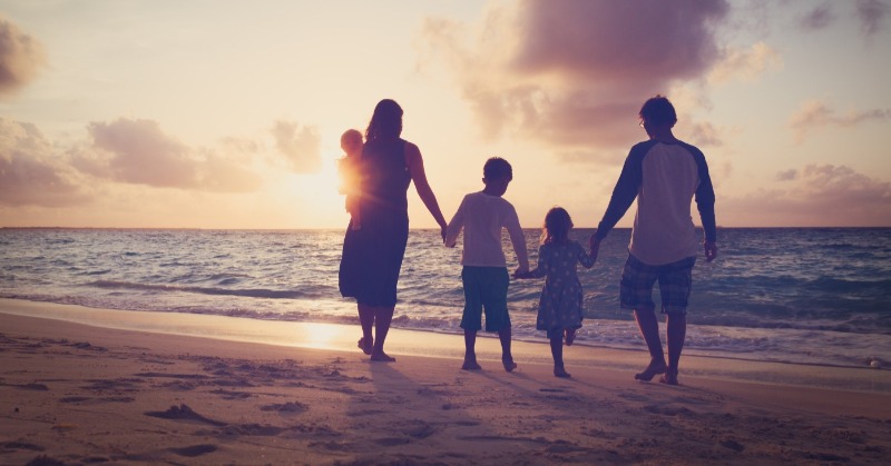 family walking on the beach | Plumlee Realty