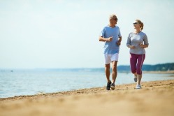 couple jogging on the beach | Plumlee Gulf Beach Realty
