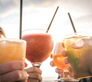 Cheers with tropical beach drinks in hand | Plumlee Indian Rocks Beach Vacation Rentals