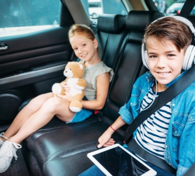 Kids happy in back seat ready for a road trip | Plumlee Indian Rocks Beach Vacation Rentals
