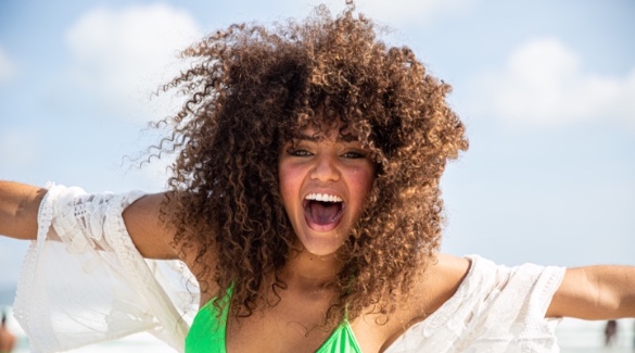 Woman with naturally curly hair on the beach | Plumlee Indian Rocks Beach vacation rentals