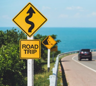 Road trip sign on road | Plumlee Indian Rocks Beach Vacation Rentals