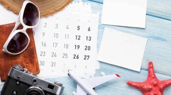 Calendar on a desk surrounded by beach stuff | Plumlee Indian Rocks Beach Rentals Florida Gulf Coast