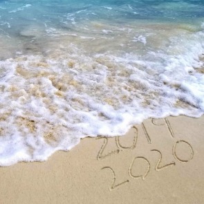 2020 written in the sand on the beach | Plumlee Realty