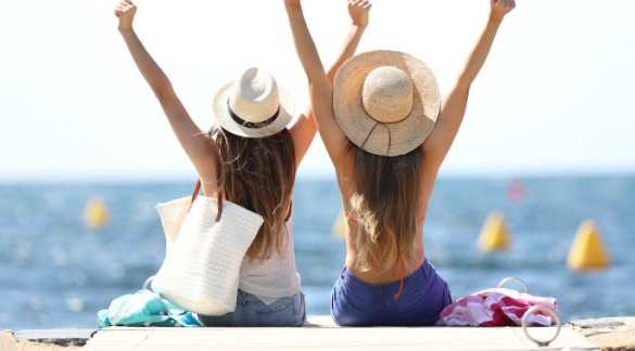 Two women in sun hats excited to be at the beach | Plumlee Indian Rocks Beach Rentals Florida Gulf Coast