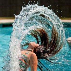 Girl Throwing Her Hair Back in the Pool Water | Plumlee Realty